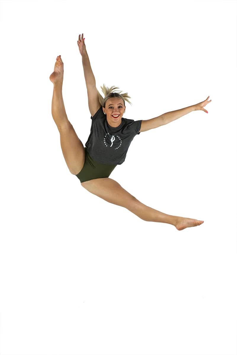 A Dance Perfections dancer captured mid split leap in the studio