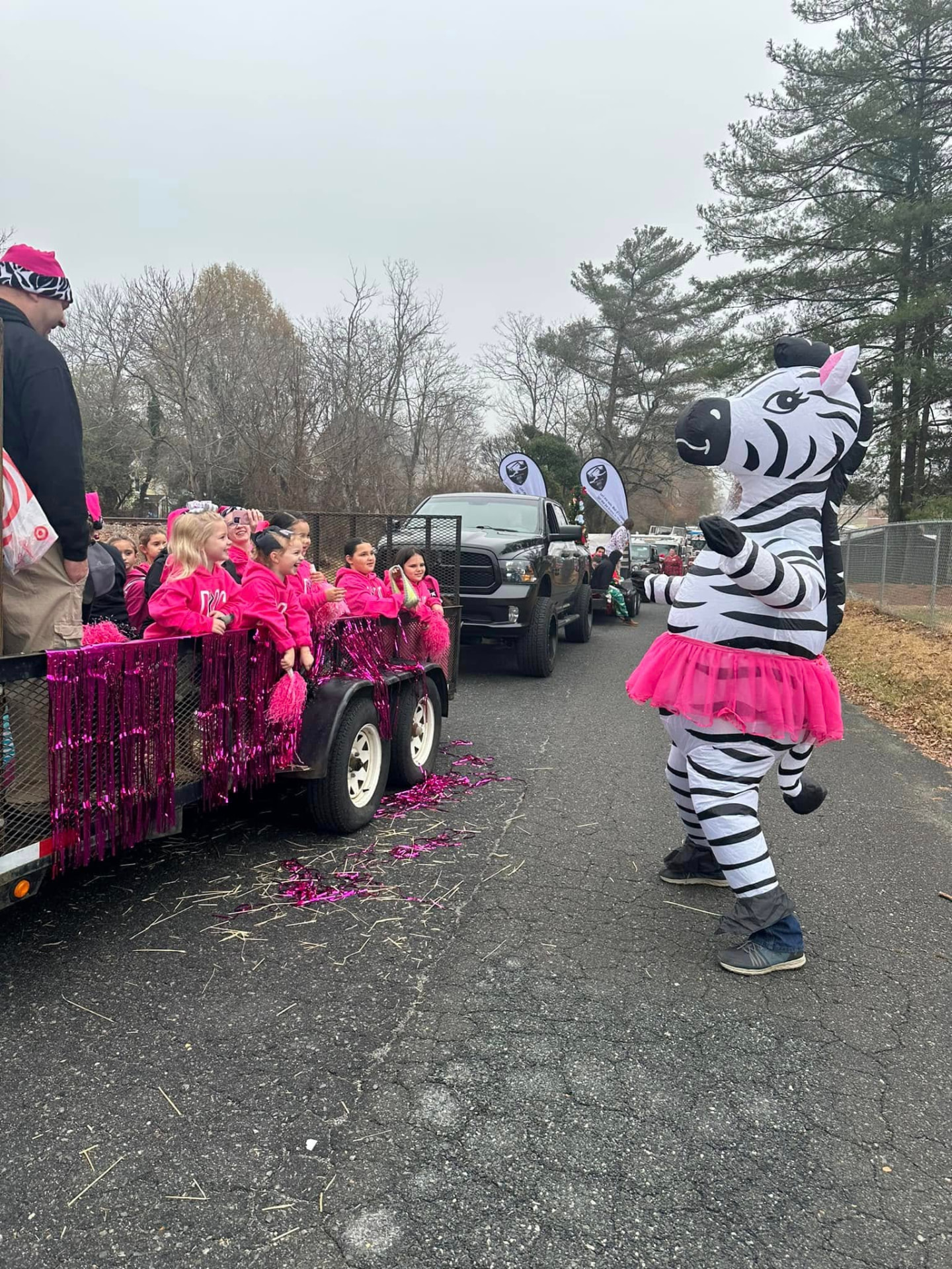 The DPAC zebra mascot dancing beside the studio float in the King Christmas parade
