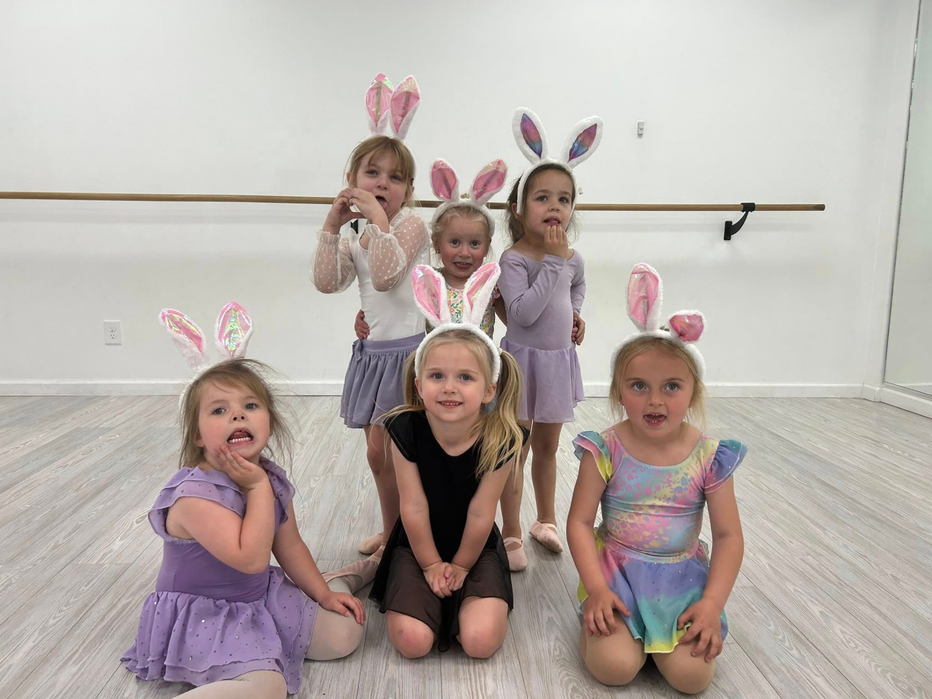 Preschool dancers wearing bunny ears posing together in the Dance Perfections studio
